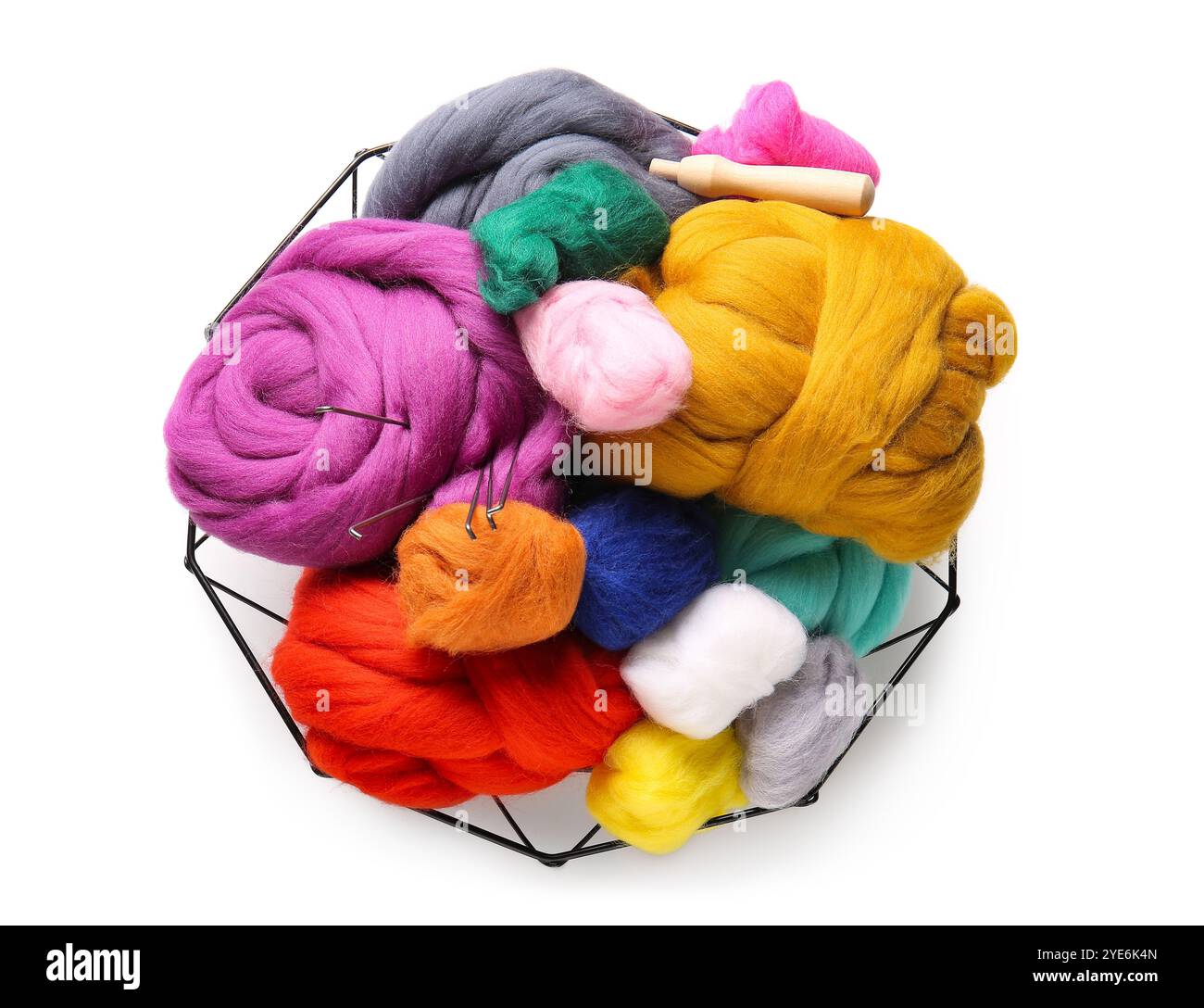 Basket with colorful wool for felting and needles on white background ...