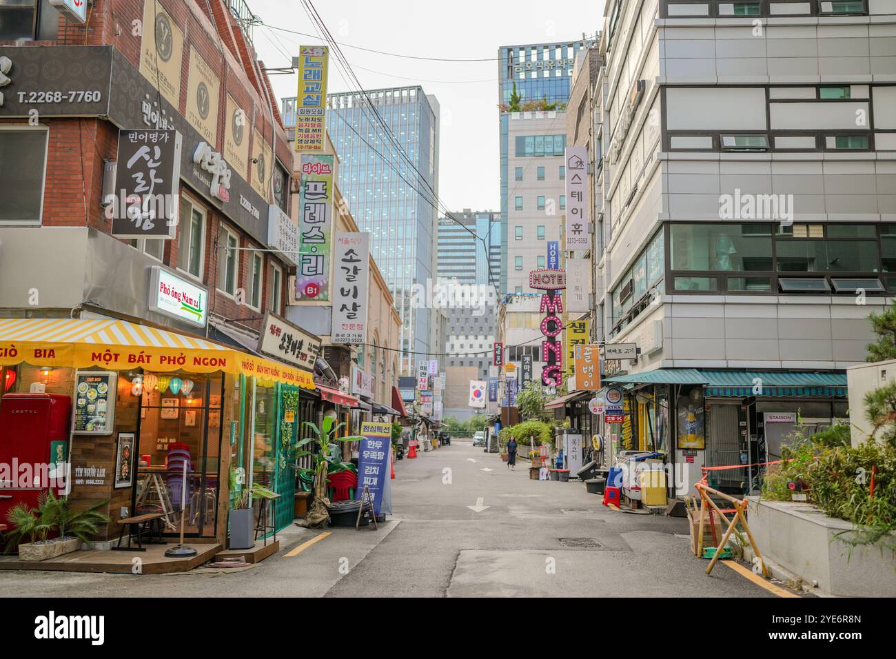 Street with many shops and restaurants. The street is busy with people ...