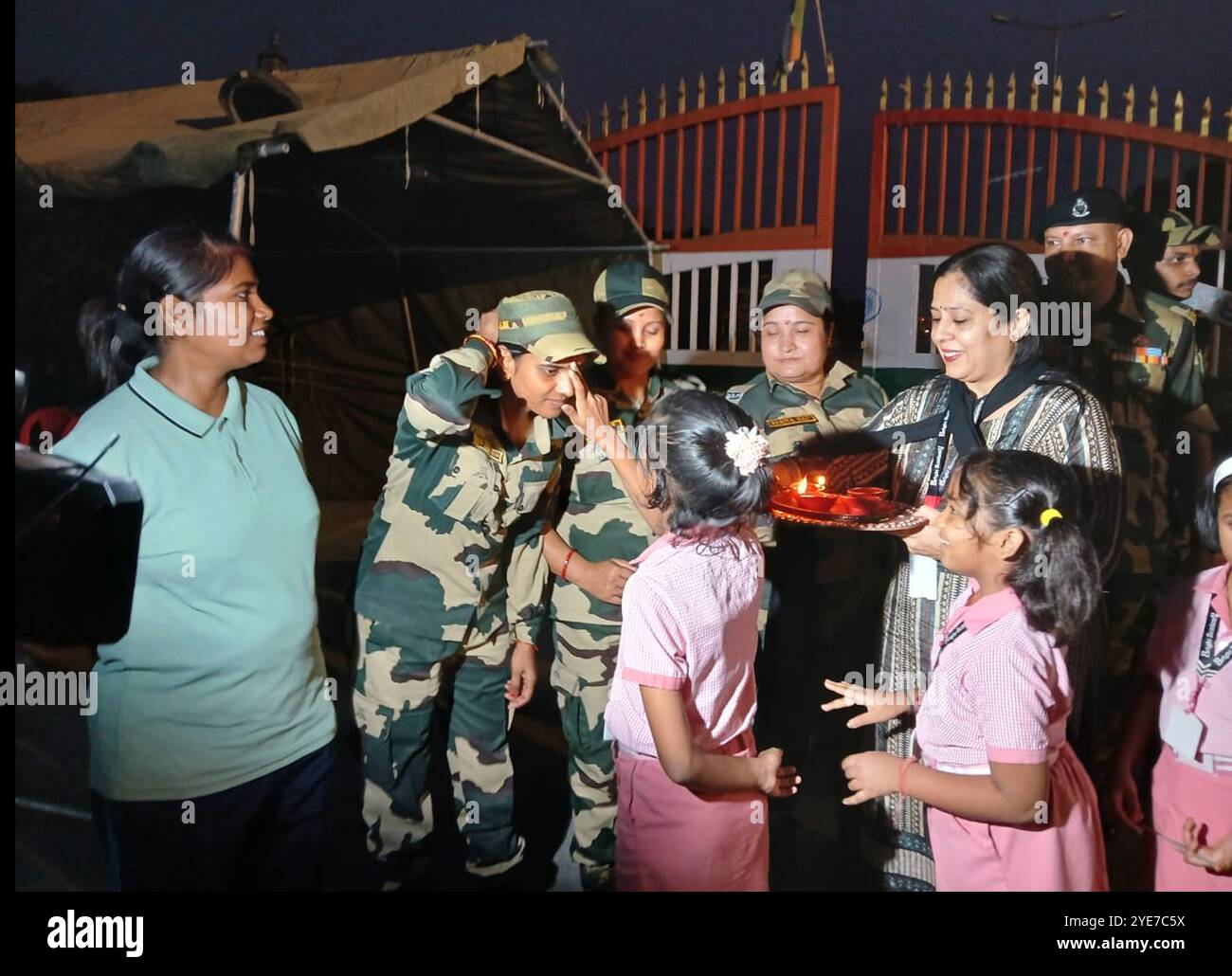 Siliguri, West Bengal, India. 30th Oct, 2024. School Children along with their Teachers of Bright Academy School holds candles and diyas as they greets the Border Security Force(BSF) personnel at Fulbari near Siliguri at India Bangalesh Border on the occasion of Diwali festival. (Credit Image: © Diptendu Dutta/ZUMA Press Wire) EDITORIAL USAGE ONLY! Not for Commercial USAGE! Stock Photo