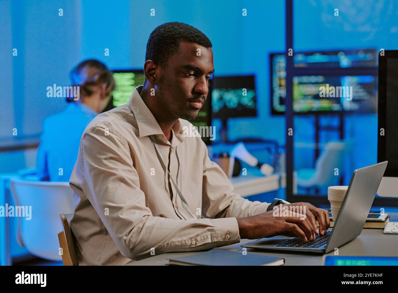 Ethical Hacker Working On Laptop In Office Stock Photo