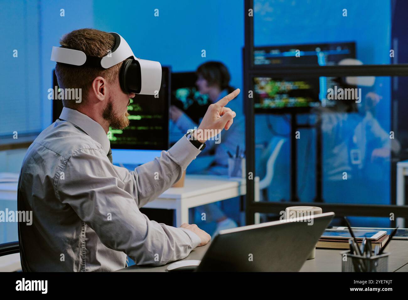 Man In VR Headset Working In Modern IT Office Stock Photo
