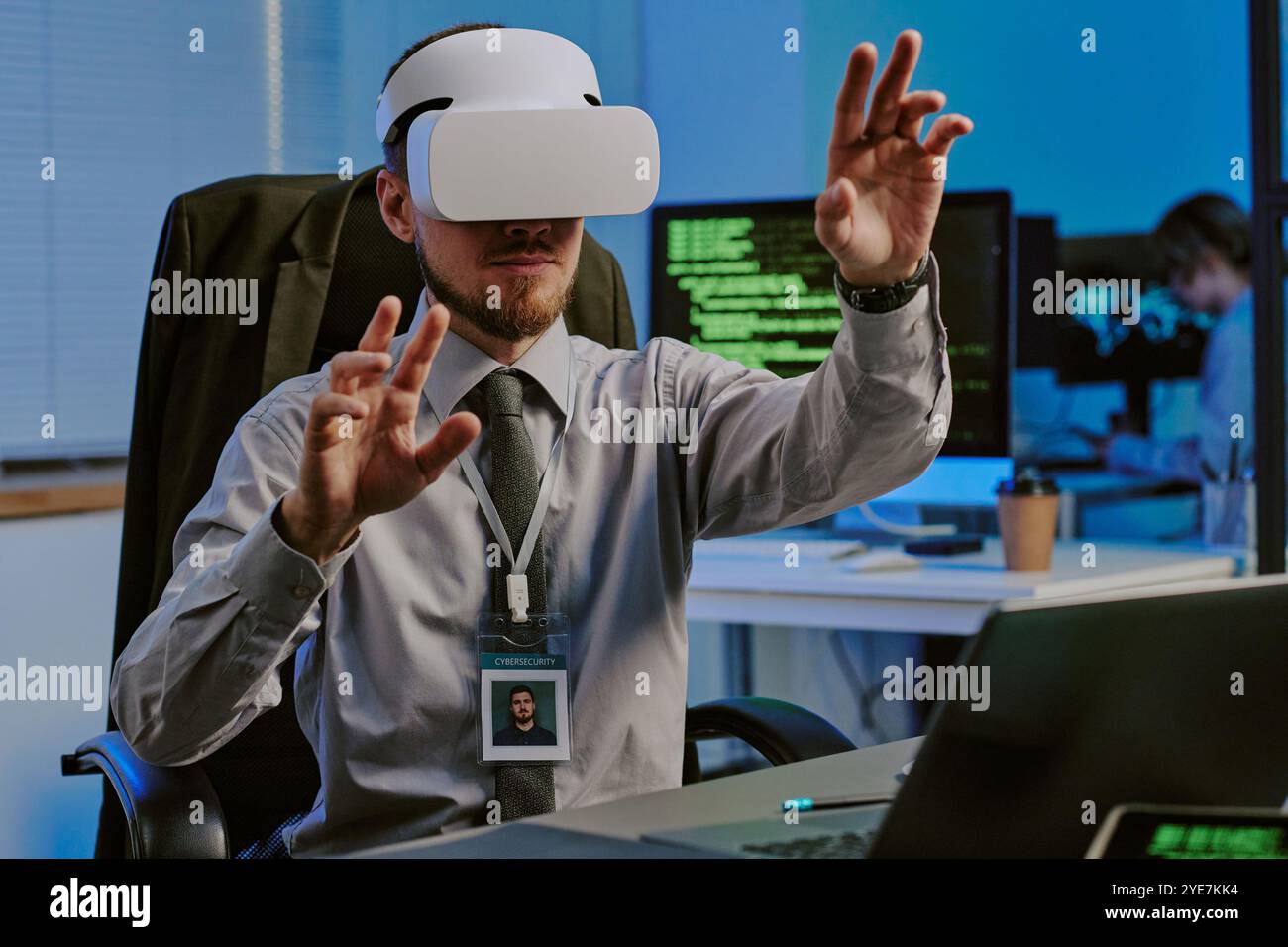 Man Using VR Headset At Work In Office Stock Photo