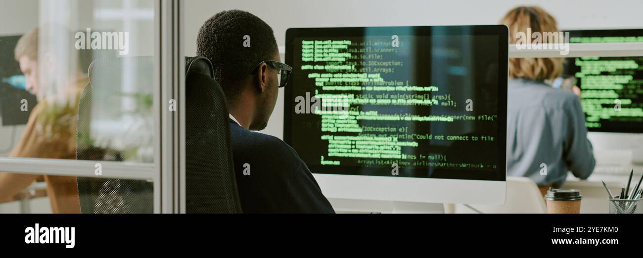Unrecognizable Black Man Coding on Computer Website Banner Stock Photo