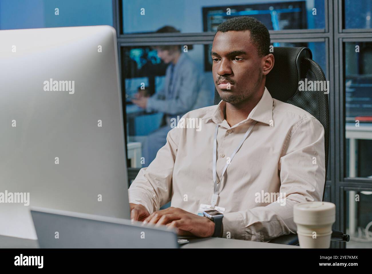 Serious Black Man Typing On Computer Stock Photo