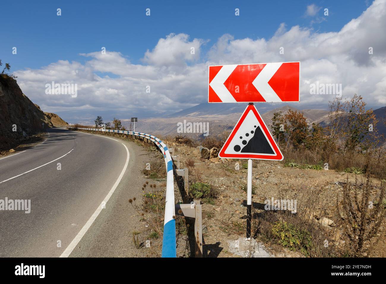 Road signs Falling stones and Direction of rotation on the road in the ...