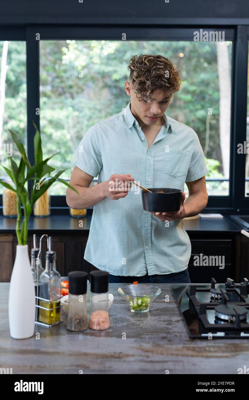 Man In Kitchen Young man at meal in kitchen hi-res stock photography and images - Alamy