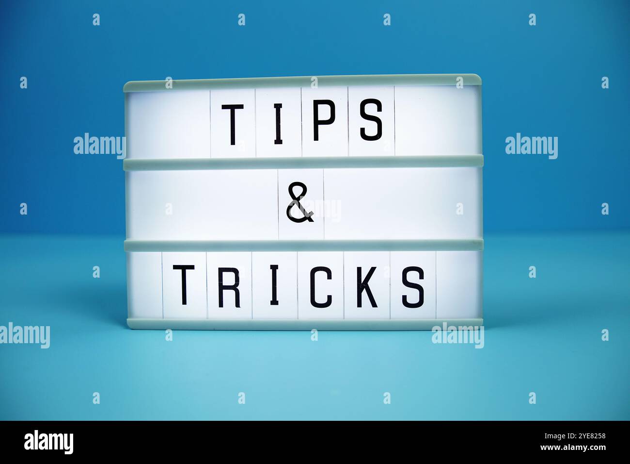 Tips & Tricks letterboard text on LED Lightbox on blue background Stock Photo