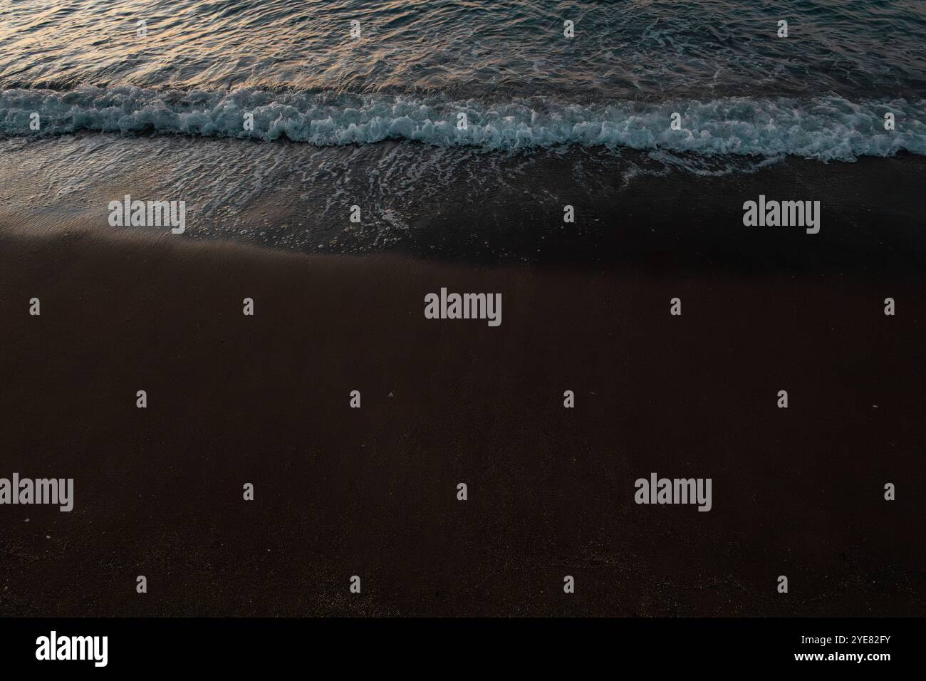 beautiful sunrise on the sea with white waves Stock Photo - Alamy