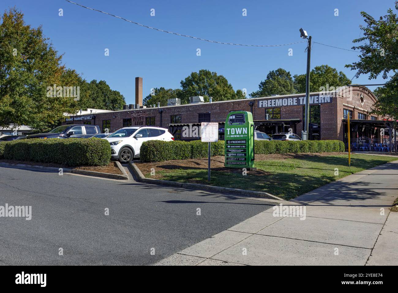 Charlotte, NC, USA-Oct. 20, 2024: Monument sign in front of building identifying Town Brewing Company, Freemore Tavern, Rhino Market, Infinity's End S Stock Photo