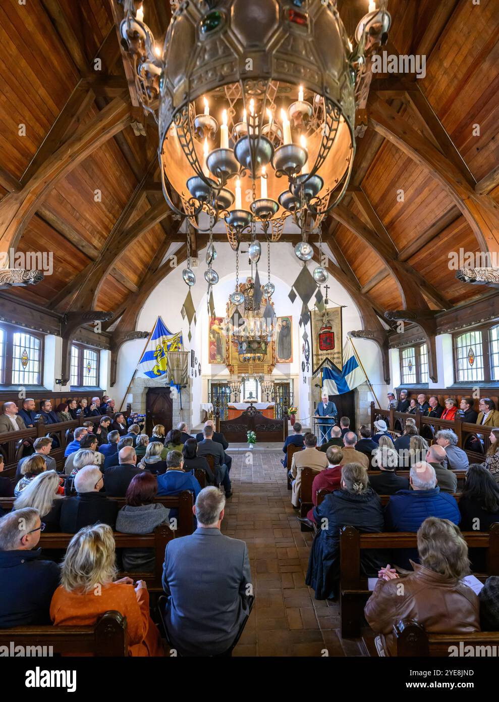 30 October 2024, Saxony-Anhalt, Lützen: Guests watch the opening of the 'Lützen 1632 Museum' in the chapel of the Lützen memorial site. The new museum building has been officially opened in the immediate vicinity of the site of a historically significant mass grave from the Thirty Years' War and next to the chapel. The exhibition provides fascinating insights into the Thirty Years' War with exhibits, graphics and pictures. The Battle of Lützen on November 6, 1632 is considered one of the most significant battles of the Thirty Years' War. Photo: Hendrik Schmidt/dpa Stock Photo