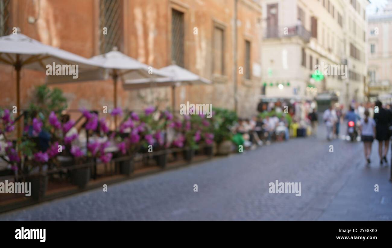 Blurred street scene in rome with defocused people strolling past ...