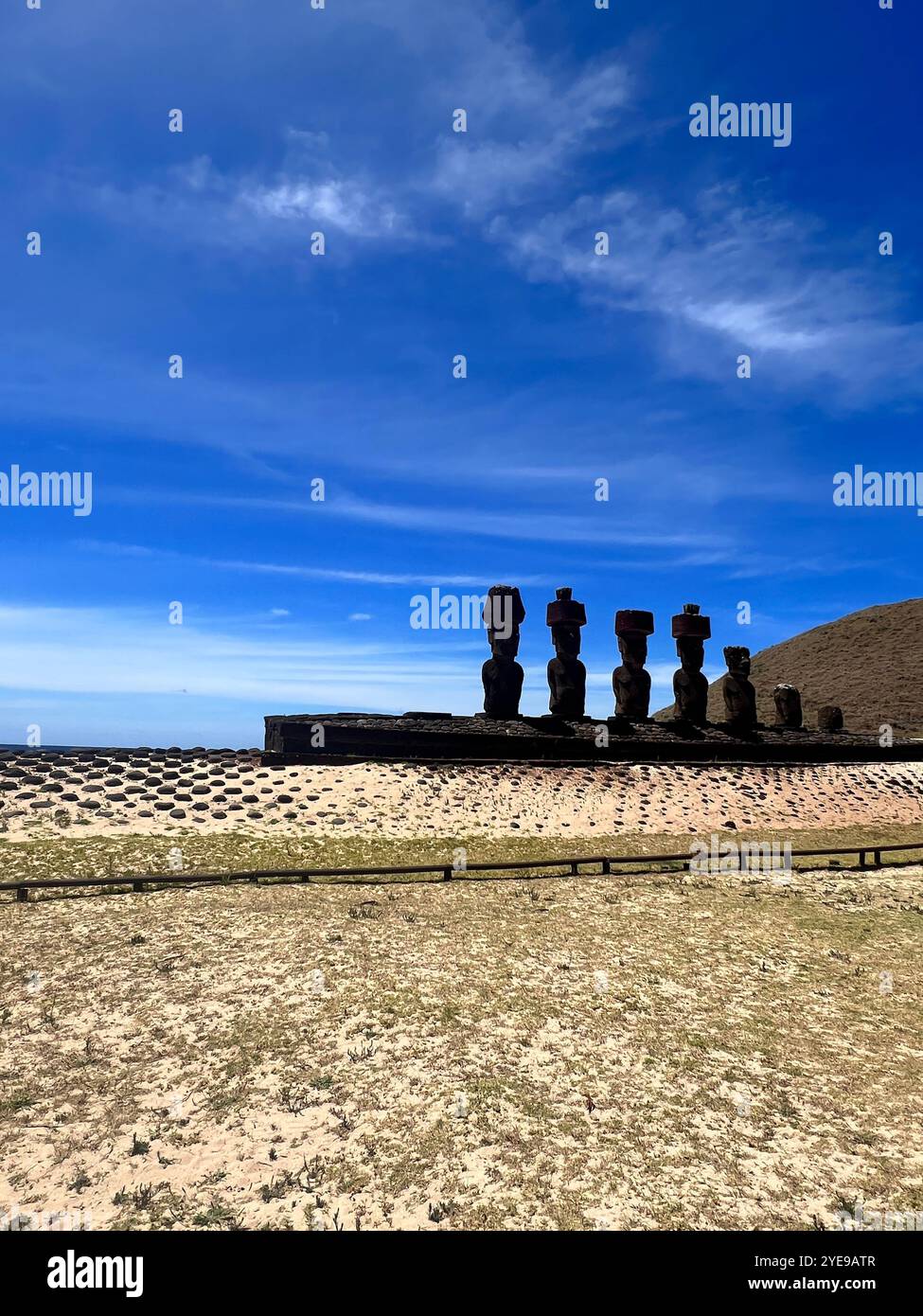 Anakena Beach on Easter Island, Chile, with iconic moai statues at Ahu Nau Nau under a blue sky combining cultural heritage with scenic tropical beach - Smartphone Captured Stock Image