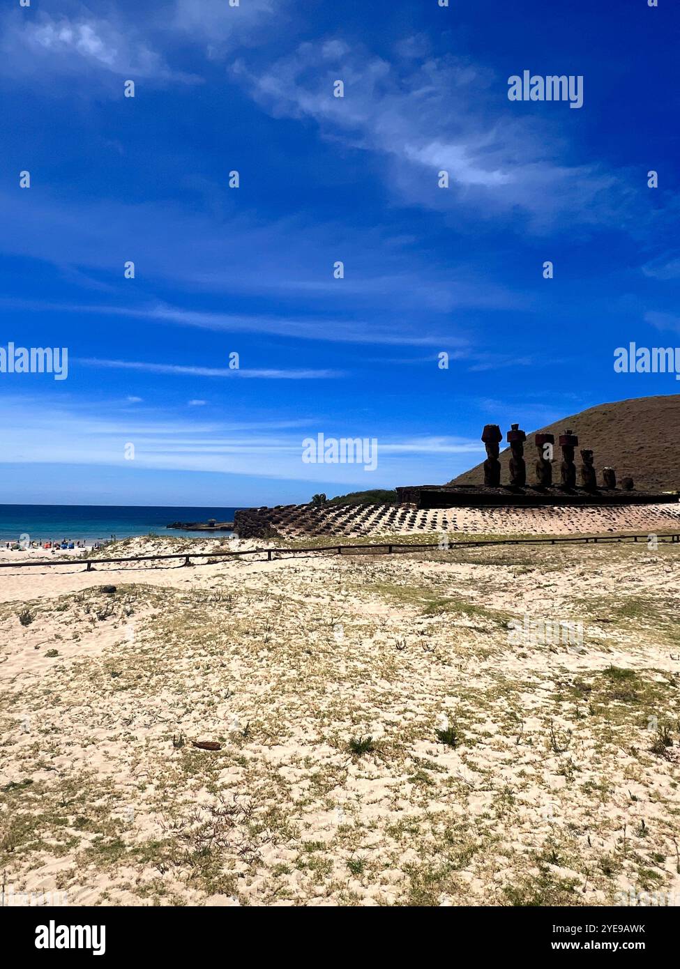 Anakena Beach on Easter Island, Chile, with iconic moai statues at Ahu Nau Nau under a blue sky combining cultural heritage with scenic tropical beach - Smartphone Captured Stock Image