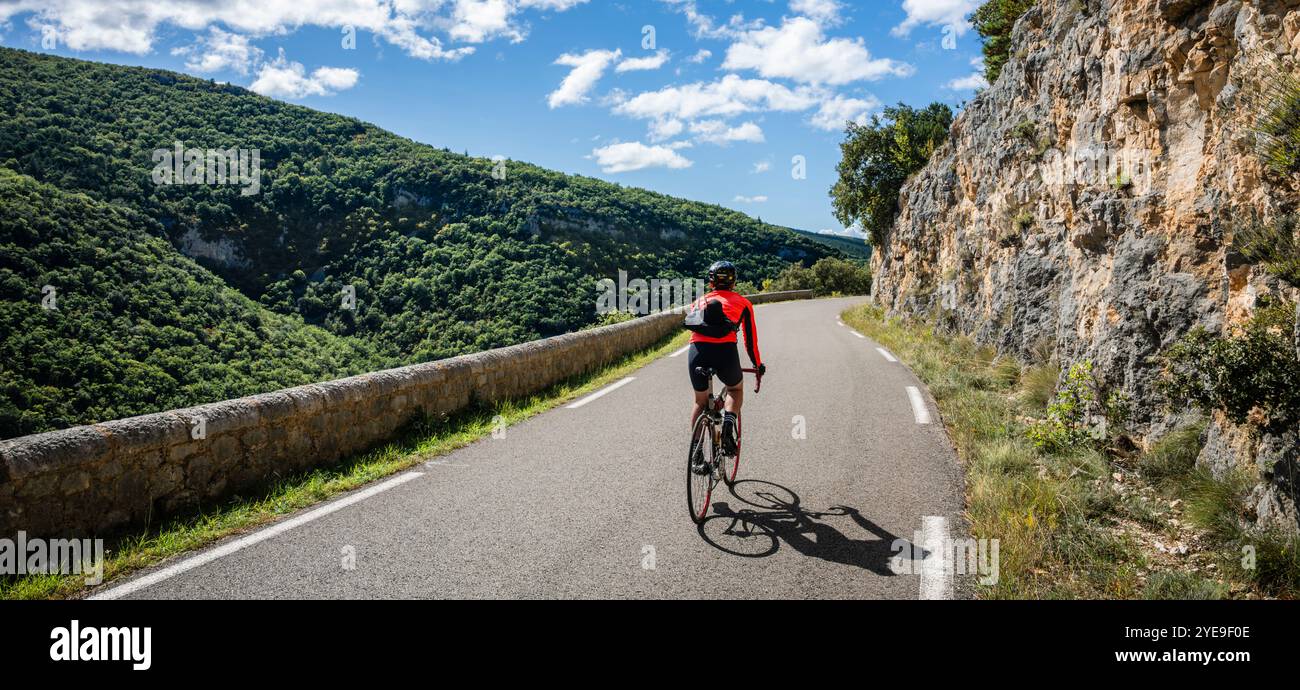 Male road cyclist descending the famous Gorges de la Nesque, Provence, France. Stock Photo