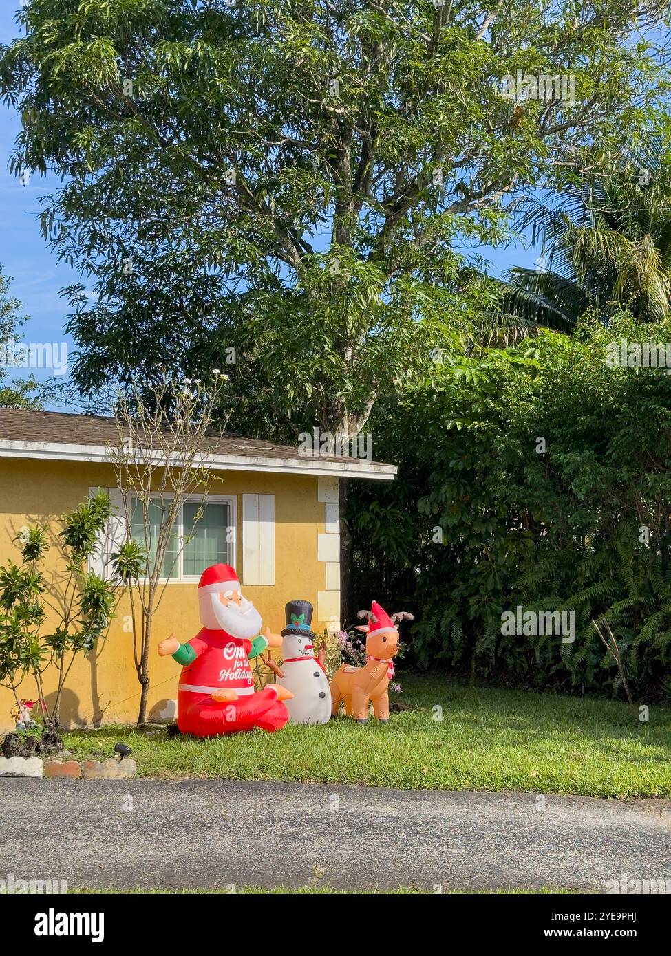 House with inflatable Chrsitmas decoration, Plantation, Florida, USA - Smartphone Captured Stock Image
