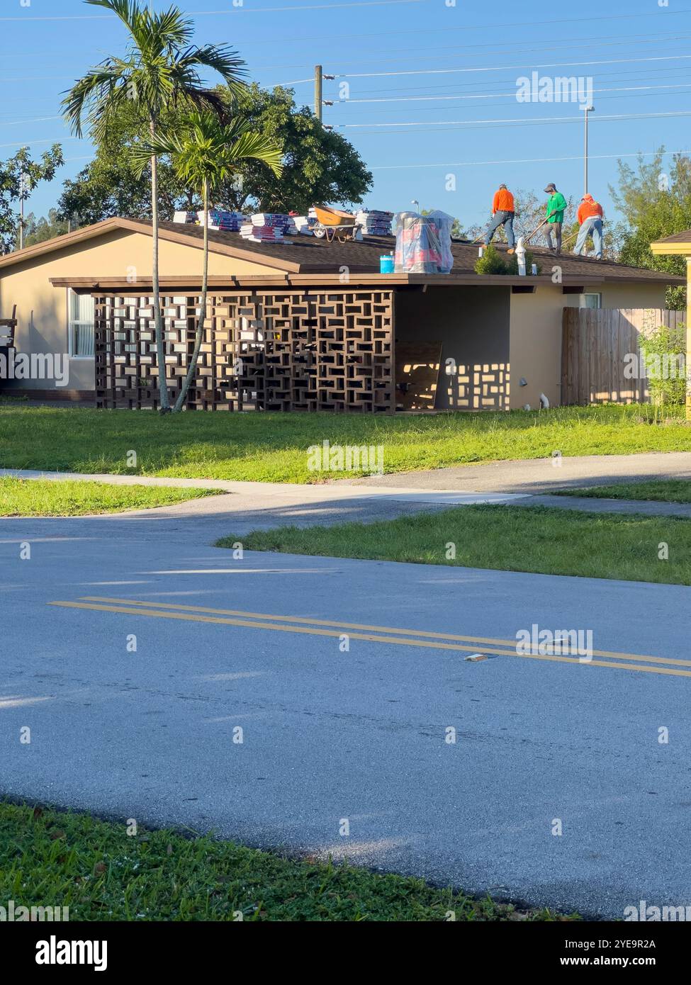 Workers doing roof repair in a house, Plantation, Florida, USA - Smartphone Captured Stock Image