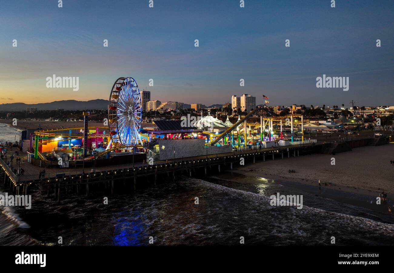 The Santa Monica Beach Pier in California, with Pacific Park at Sunset ...
