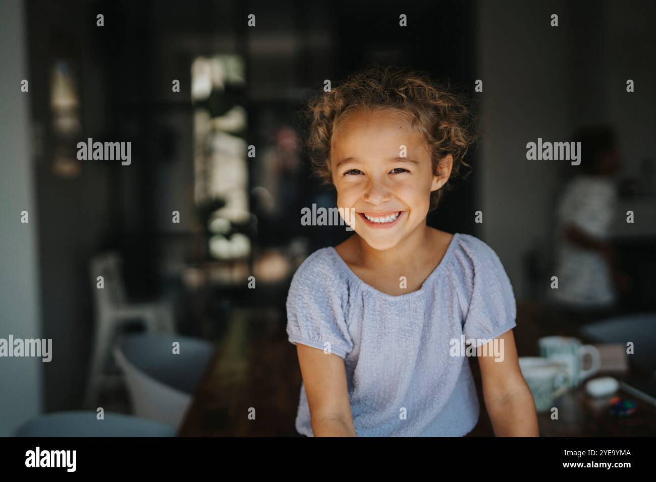 Portrait of smiling cute girl with curly hair Stock Photo - Alamy