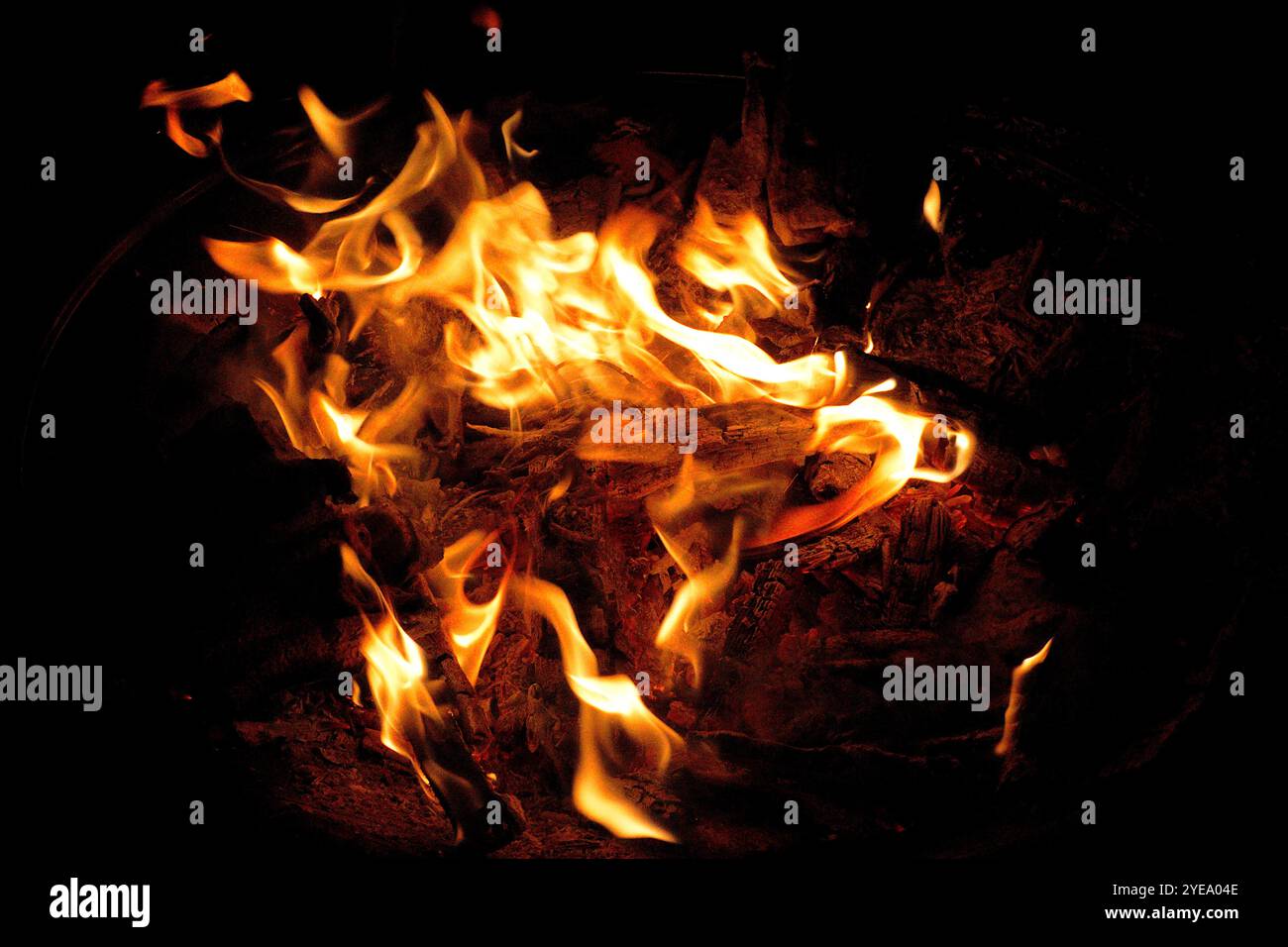 Flames dance in a fire pit accompanied by a cool breeze on November 5th. Stock Photo