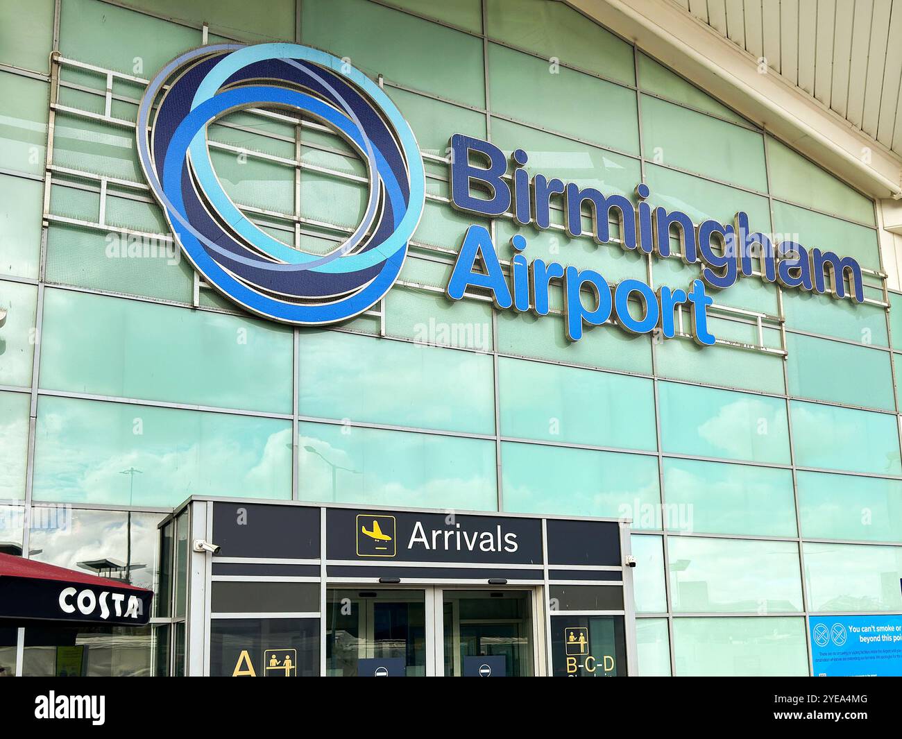 Birmingham, West Midlands, UK: Exterior view of the arrivals entrance of the Birmingham airport terminal building. - Smartphone Captured Stock Image Birmingham, West Midlands, UK: Exterior view of the arrivals entrance of the Birmingham airport terminal building. - Smartphone Captured Stock Image