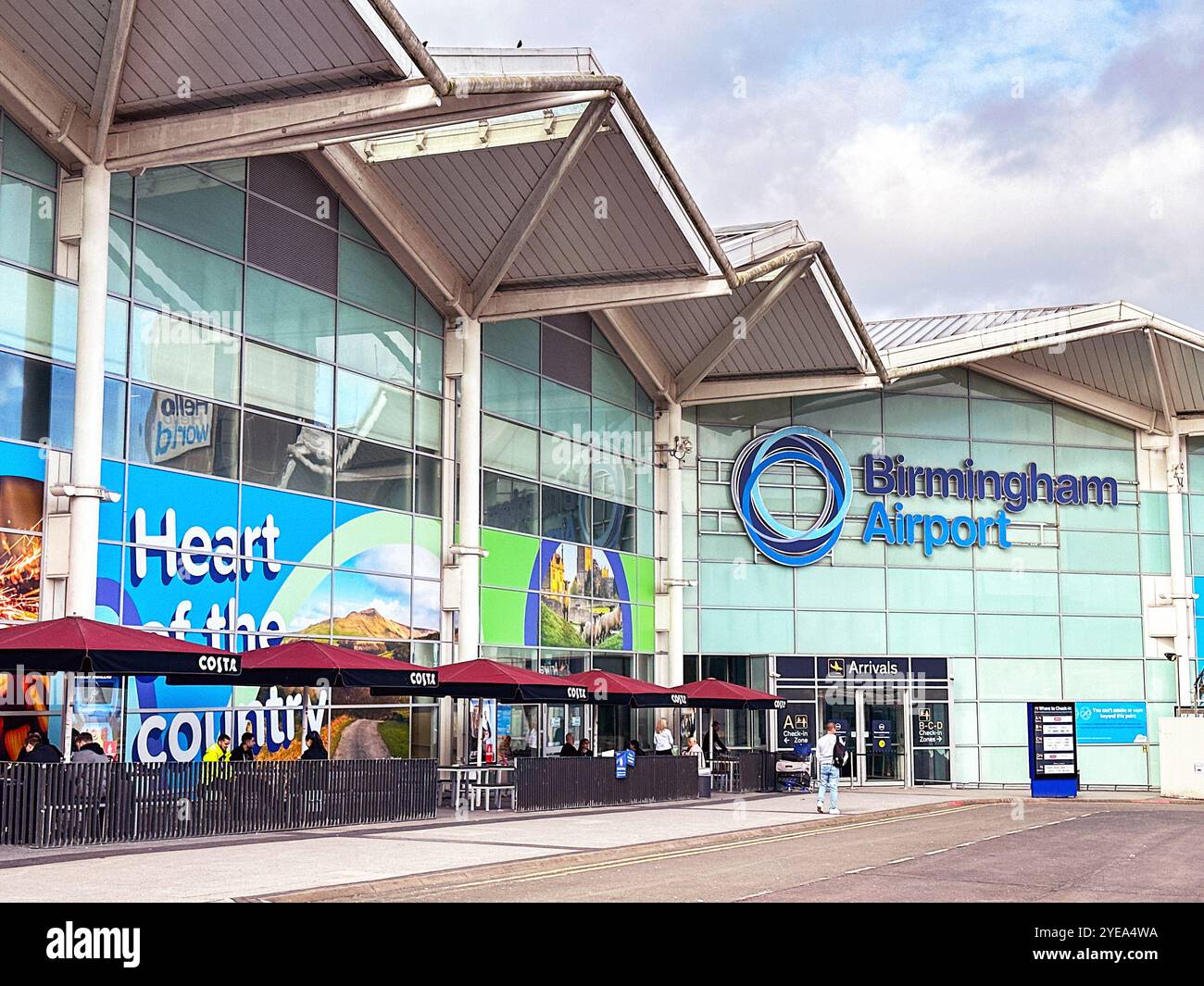 Birmingham, West Midlands, UK: Exterior view of the arrivals entrance of the Birmingham airport terminal building. - Smartphone Captured Stock Image