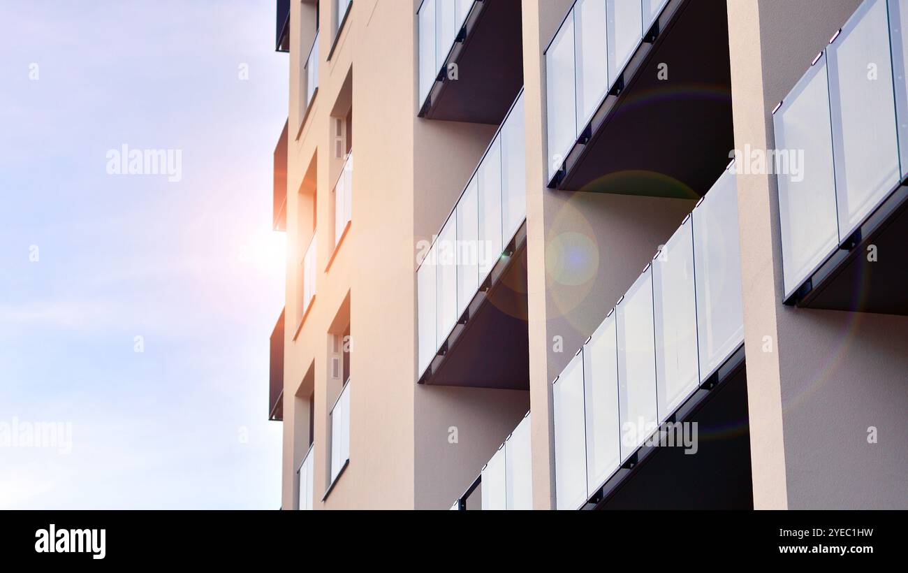 Picture of Modern high-rise apartment building in white, stand tall against a blue ...