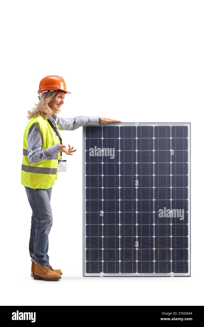 Female engineer standing next to a solar panel and talking isolated on white background Stock Photo