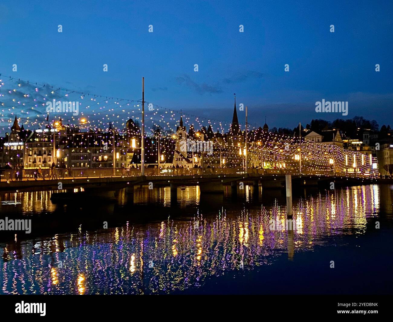 City Bridge Illuminated With Festive Lights During Twilight - Smartphone Captured Stock Image