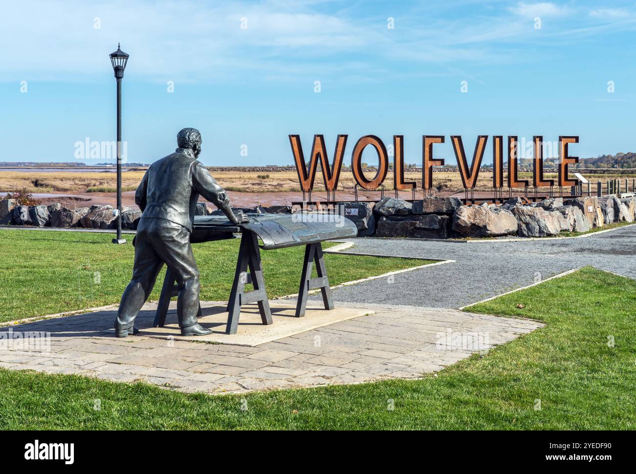 Sculpture in Waterfront Park in Wolfville Nova Scotia. The sculpture is of T.T. Vernon Smith, an entrepreneur and engineer. The sculpture depicts Vern Stock Photo