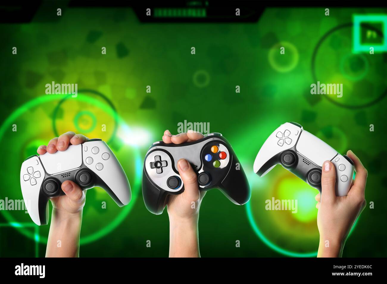 Friends with joysticks playing video game, closeup Stock Photo