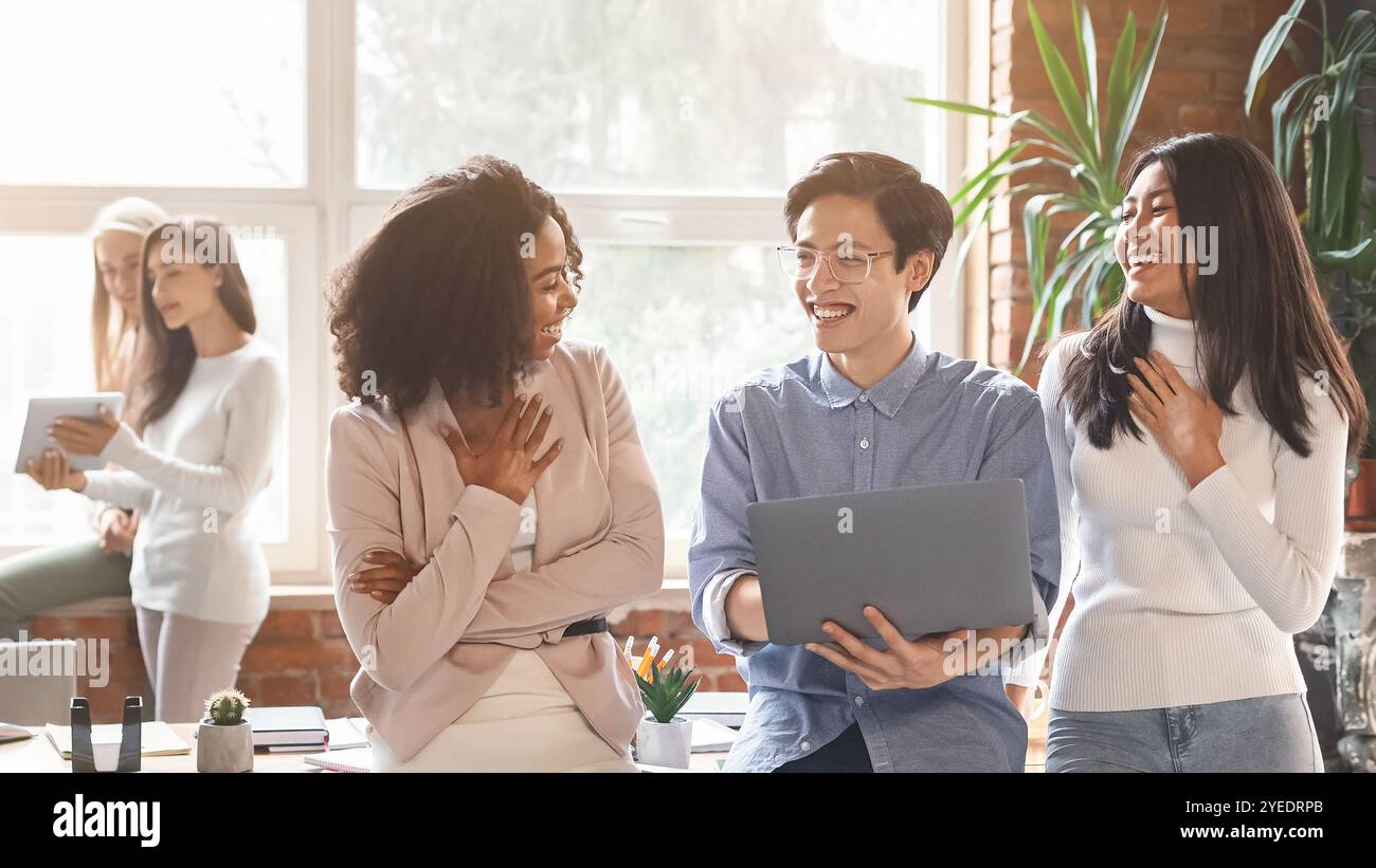 Friendly multiracial colleagues having conversation in office Stock Photo