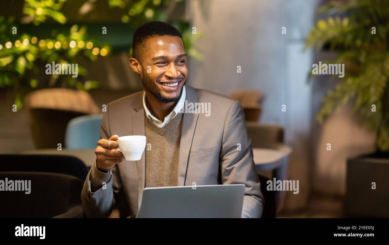 Afro manager drinking tea and using personal computer Stock Photo