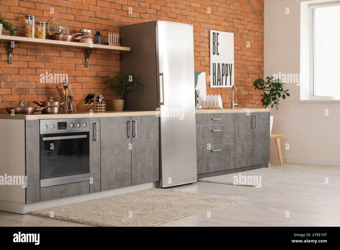 Interior of modern kitchen with silver fridge, counters and shelf Stock ...