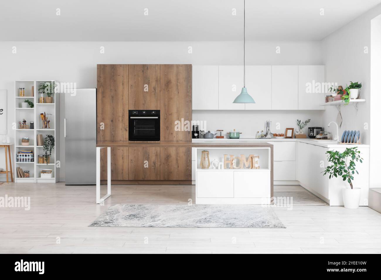 Interior of light kitchen with silver fridge, white counters and shelf ...