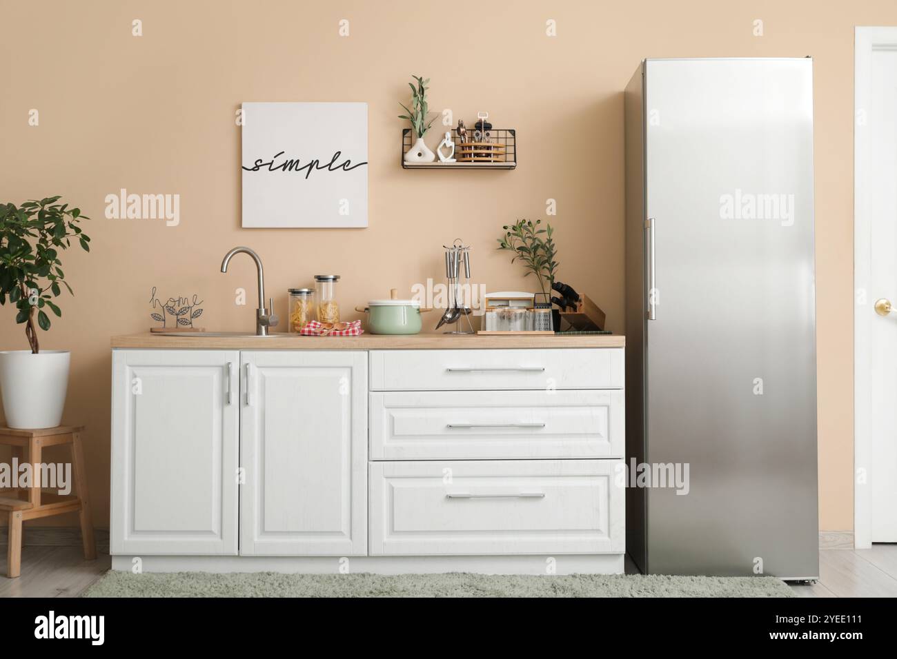 Interior of kitchen with silver fridge, counters and shelf Stock Photo ...