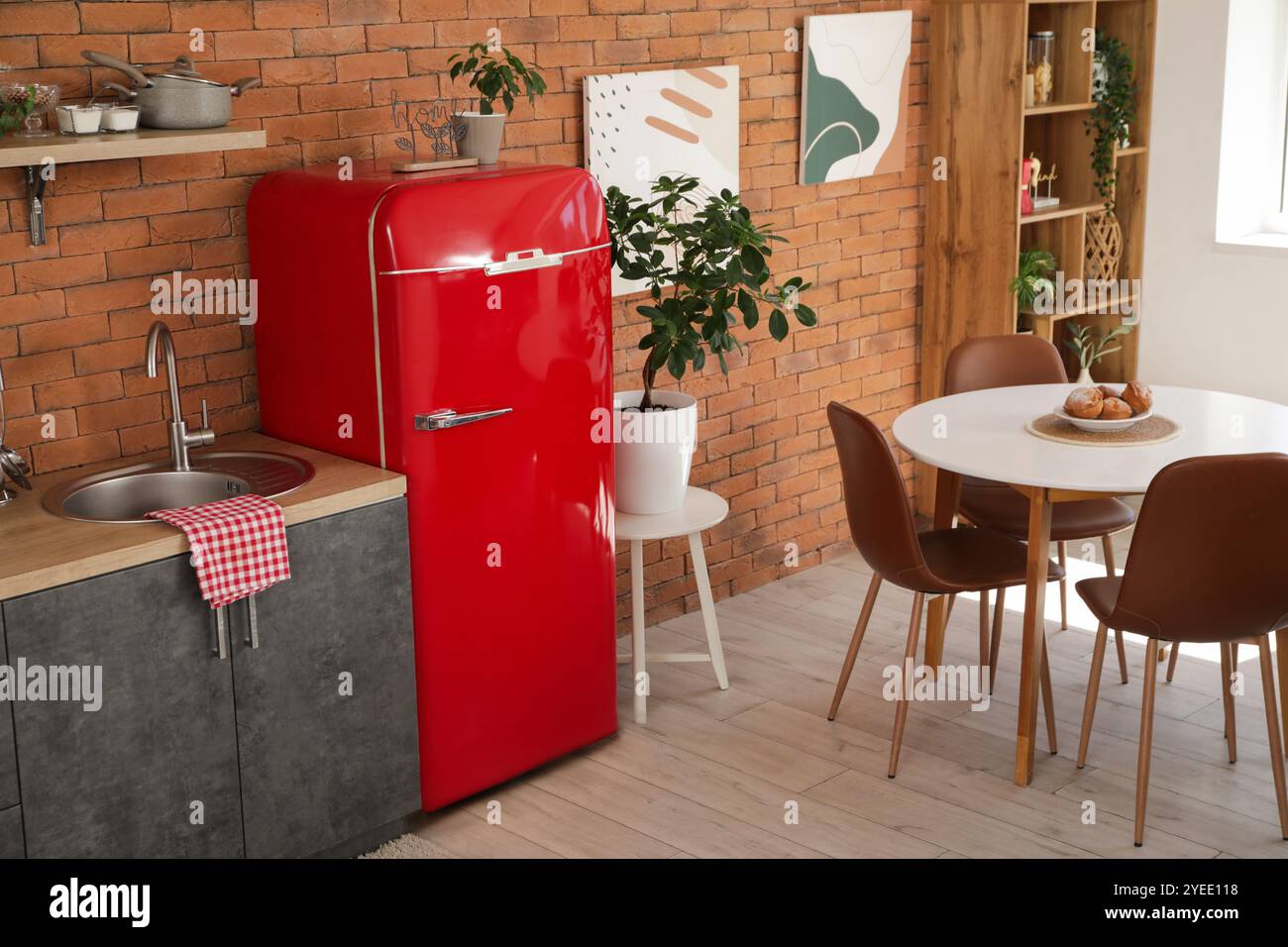 Interior of modern kitchen with red fridge, sink and dining table Stock ...