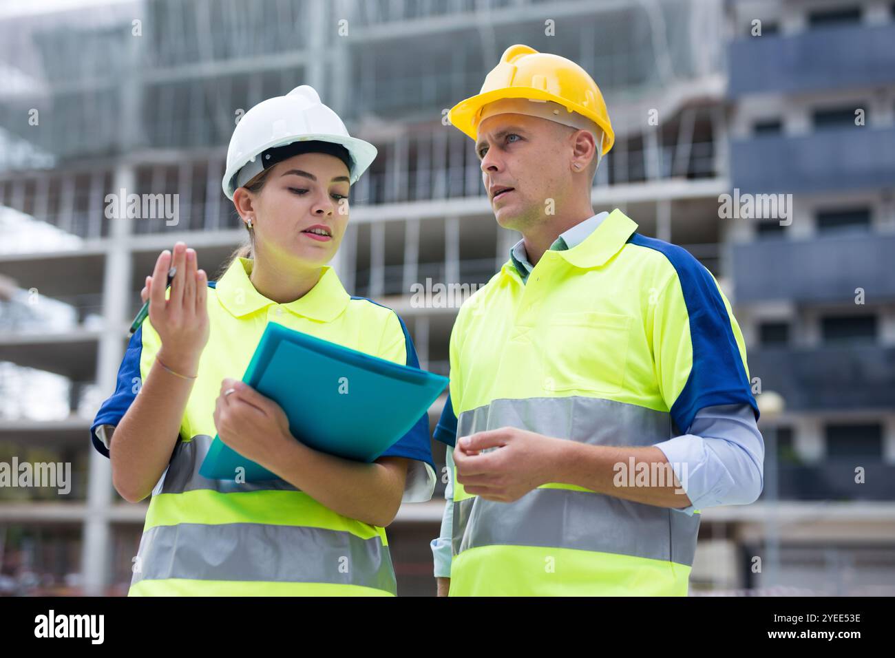 Two qualified engineers are discussing a construction plan Stock Photo