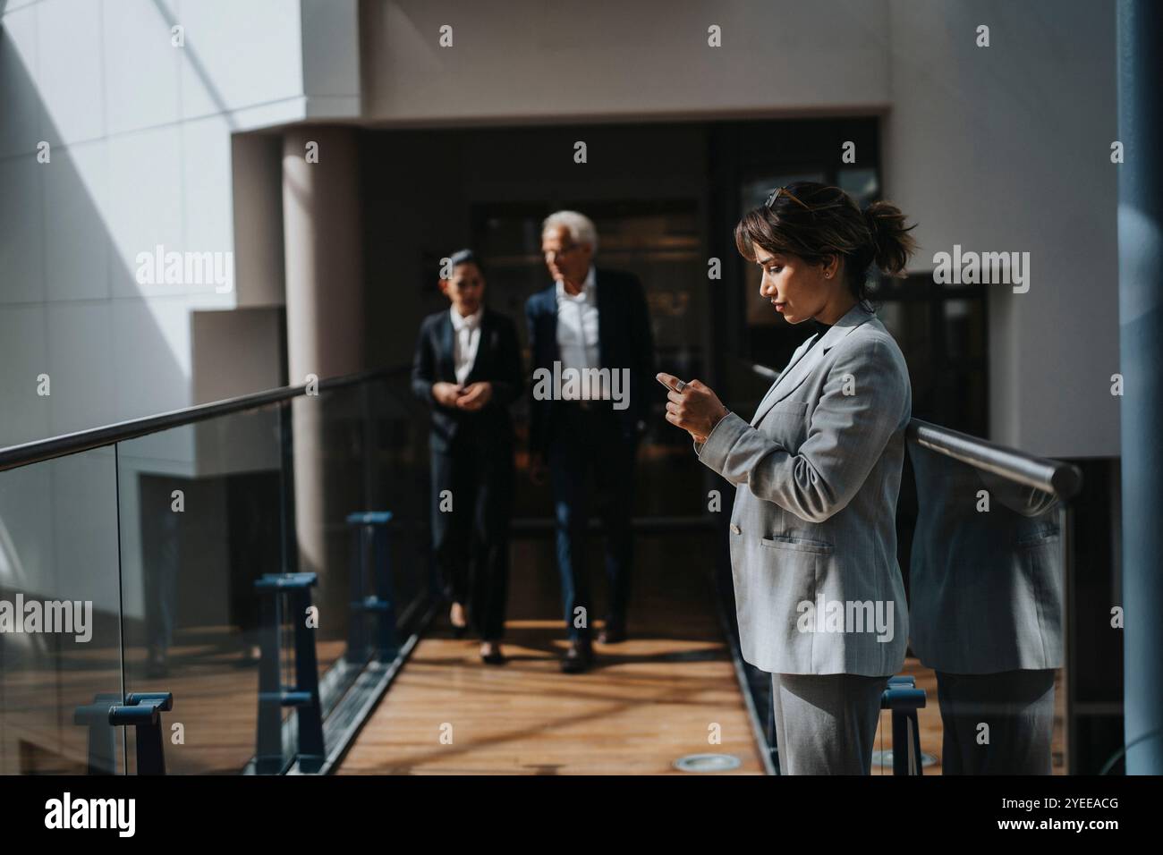 Side view of businesswoman standing in lobby Stock Photo