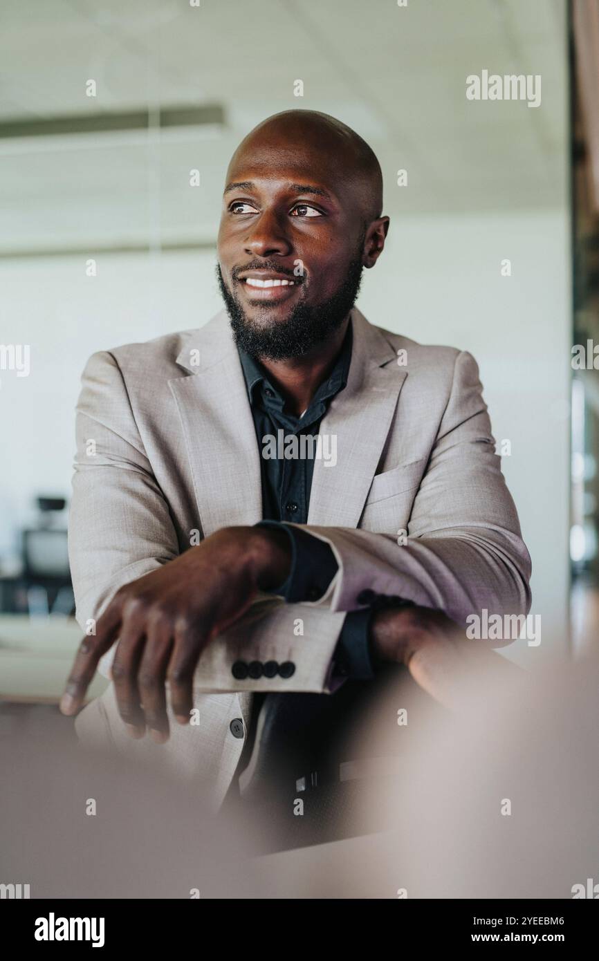 Smiling bald businessman standing in office Stock Photo