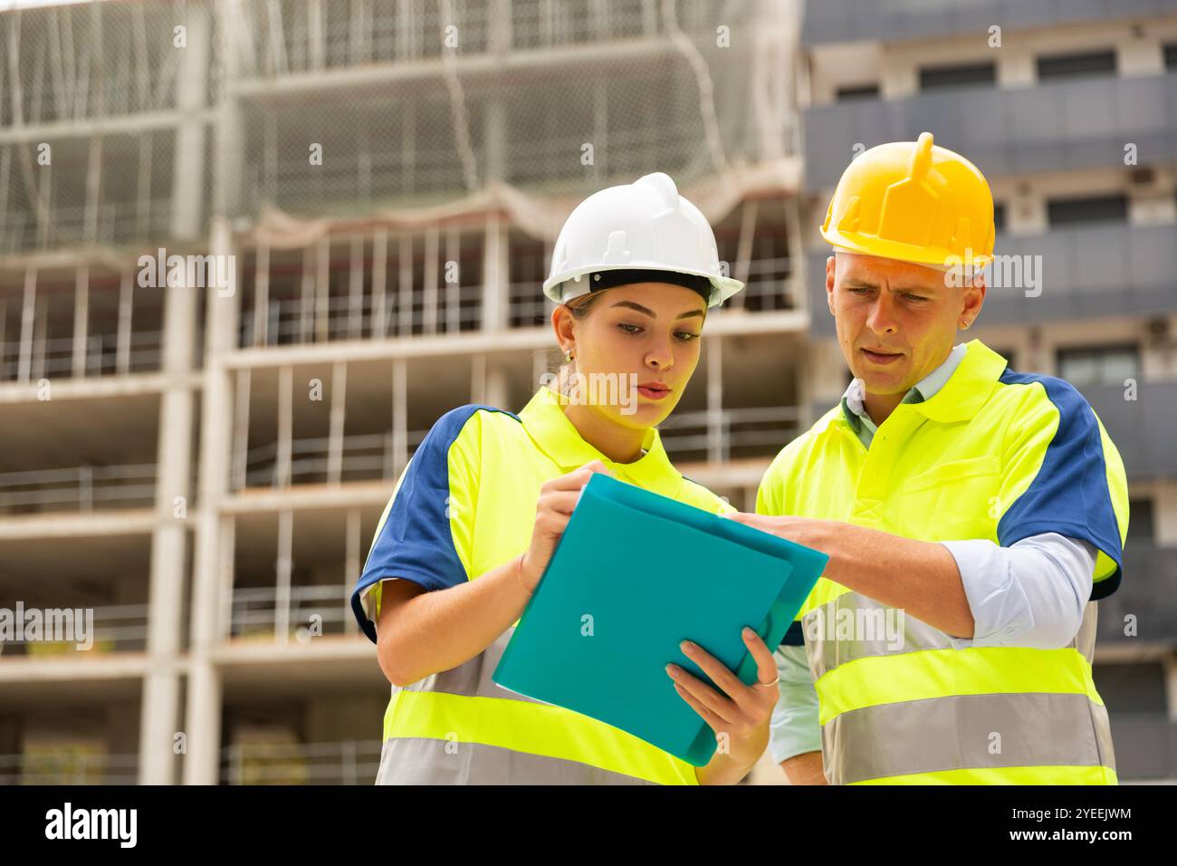 Two qualified engineers are discussing a construction plan Stock Photo