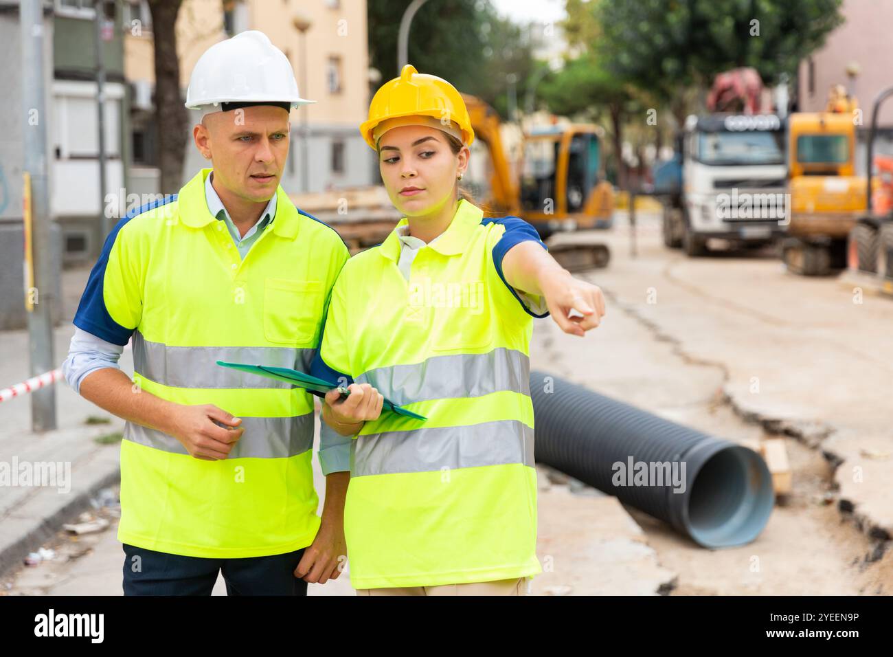 Two qualified engineers are discussing a construction plan Stock Photo