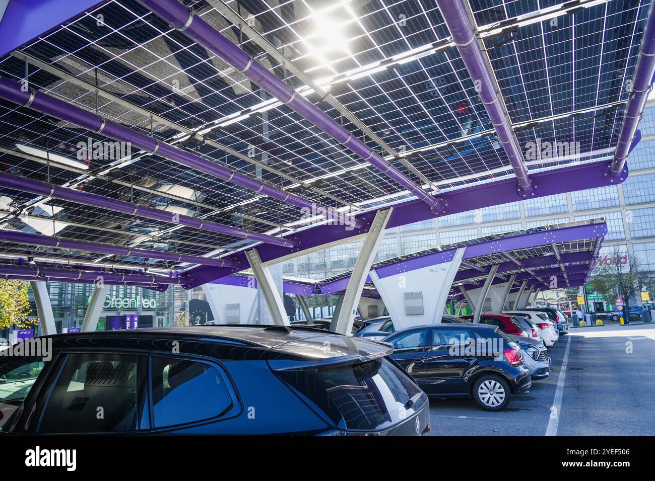 Innovative car park with solar canopies. Companies are installing renewable energy sources to reduce their carbon footprint..  Turin, Italy - October Stock Photo