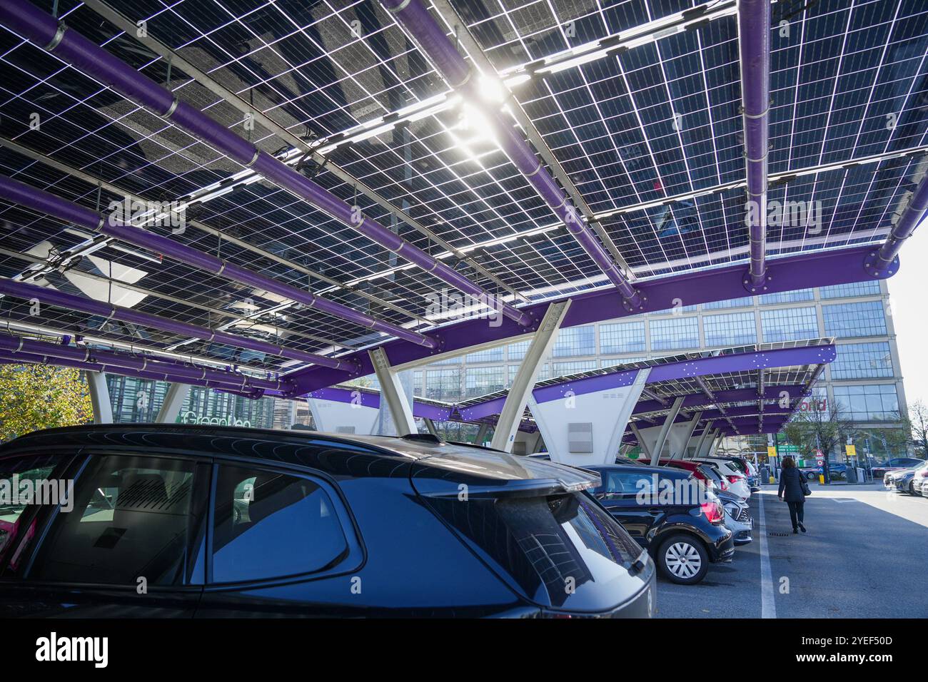 Innovative car park with solar canopies. Companies are installing renewable energy sources to reduce their carbon footprint..  Turin, Italy - October Stock Photo