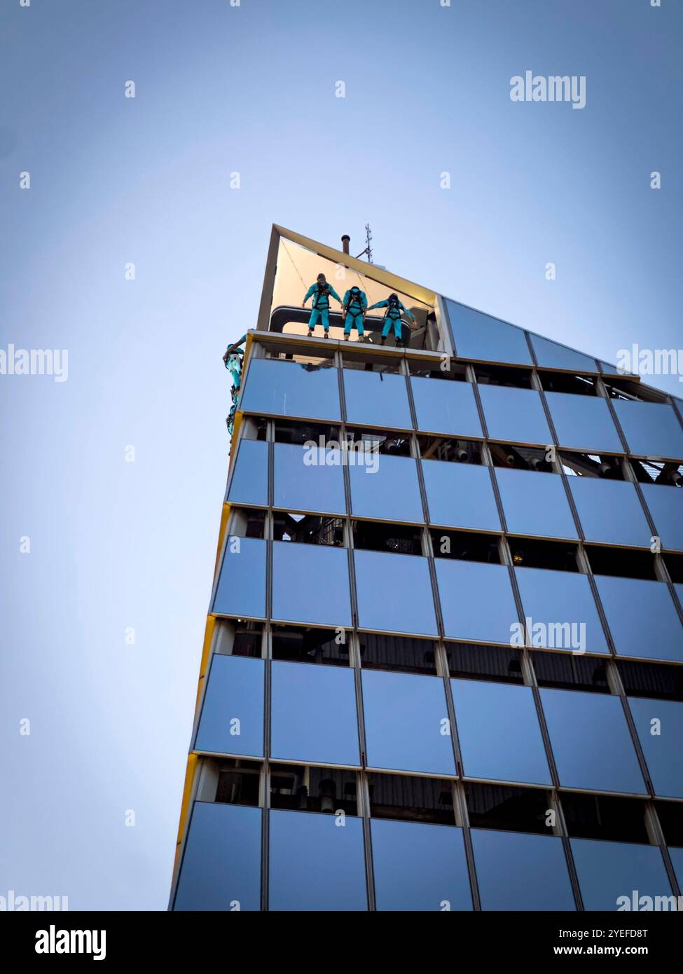 Group of people wearing uniforms standing on top of The edge ,hudson yards, new york, city latest tourist attraction highest sky deck - Smartphone Captured Stock Image