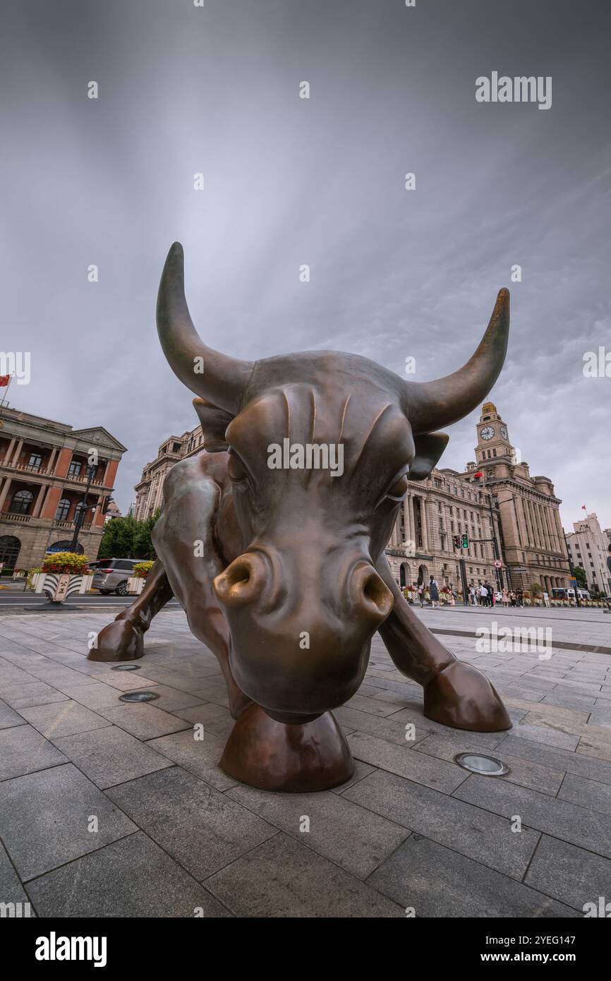 Shanghai, China - December 30, 2022: Bronze bull on The Bund in Shanghai, Iron bull statue in front of Chinese banks on the Waitan Bund promenade, Sha Stock Photo