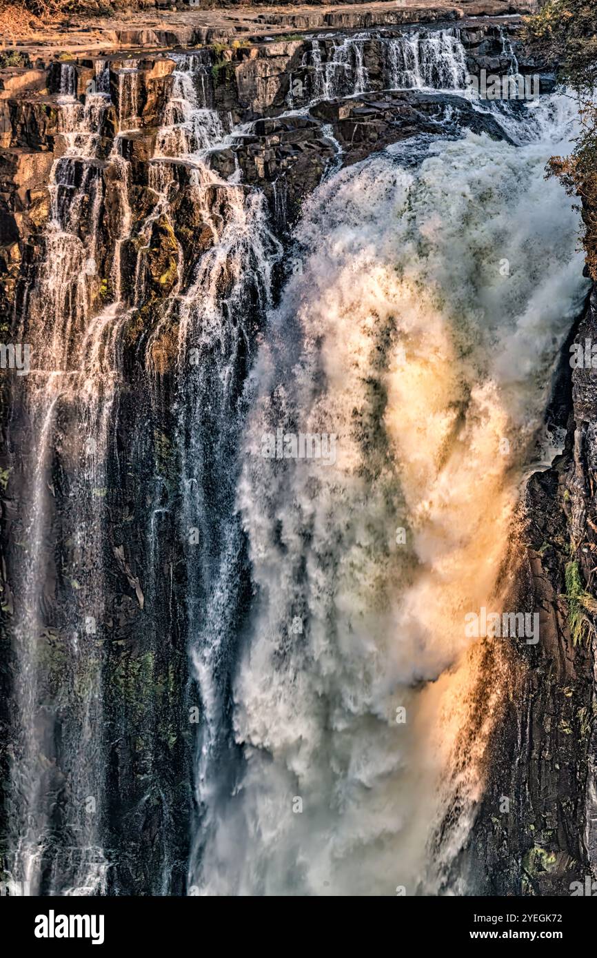 A close-up view of a waterfall's edge captures the roaring water and intricate textures, highlighting untamed power and fluidity. Stock Photo