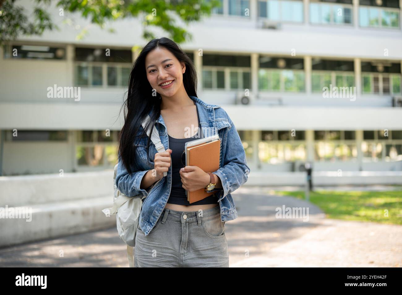 Portrait of an attractive Asian female college student in casual ...