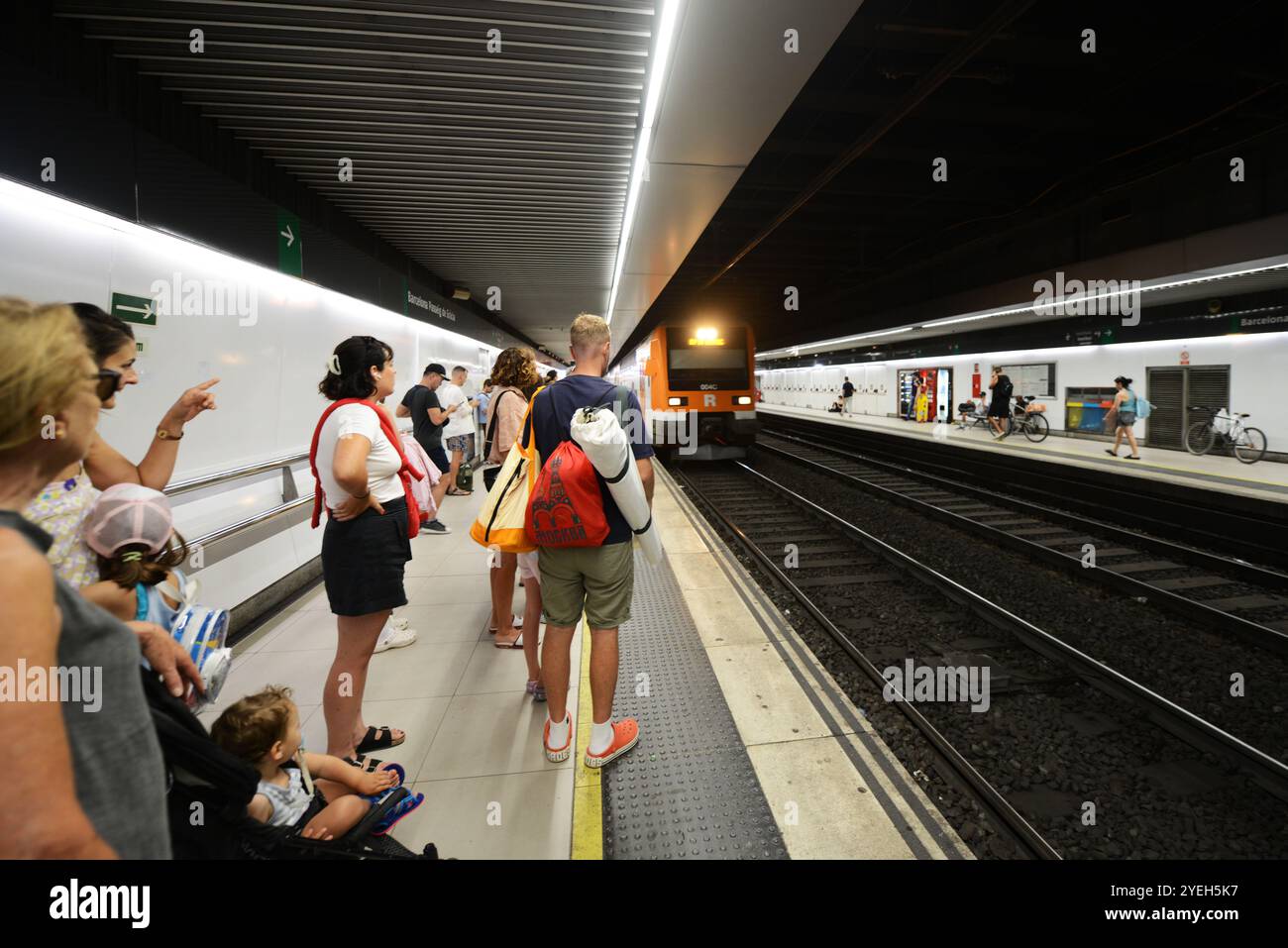 Passengers waiting for the train on the platform at the Passeig de Gràcia train station in Barcelona, Spain. Stock Photo