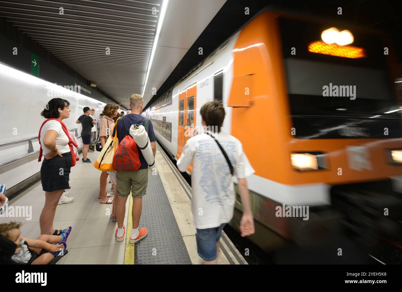 Passengers waiting for the train on the platform at the Passeig de Gràcia train station in Barcelona, Spain. Stock Photo