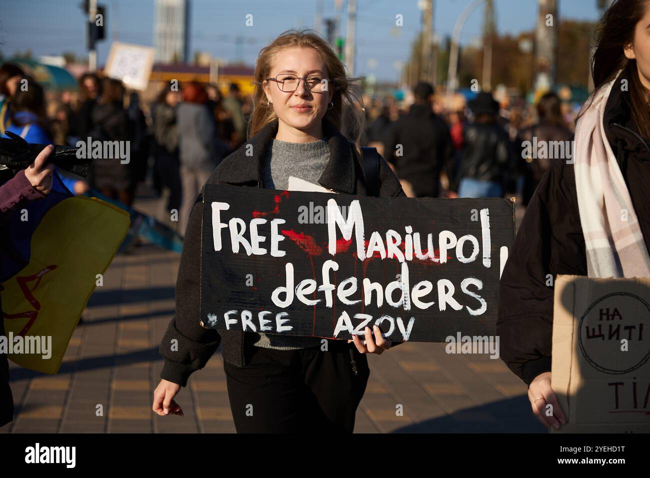 Young Ukrainian woman walks with a sign 